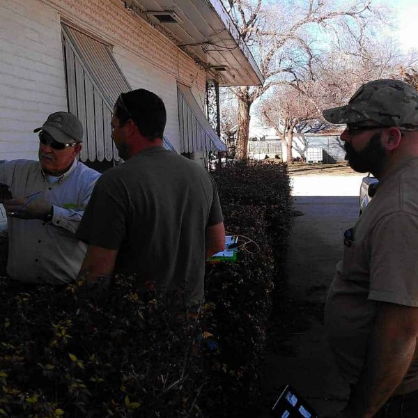 Employees (from left) Jimmy Ridgeway, Travis Ridgeway, and Matt Smith work at splicing a customer's house into the new fiber network.
