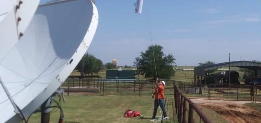 Workers from MUTI raise a replacement antenna and radios on our North Carnegie site. The old antenna had been struck by lightning early the previous morning, during a brief but powerful storm.