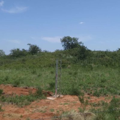 The base section of tower is set in concrete atop a hill south of Fort Cobb Lake. 